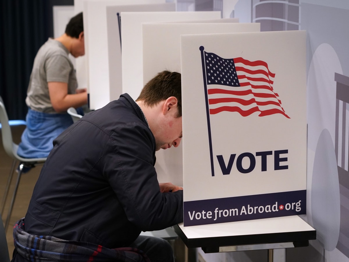 Voters casting ballots at polling station, representing state-controlled election administration and privacy protection