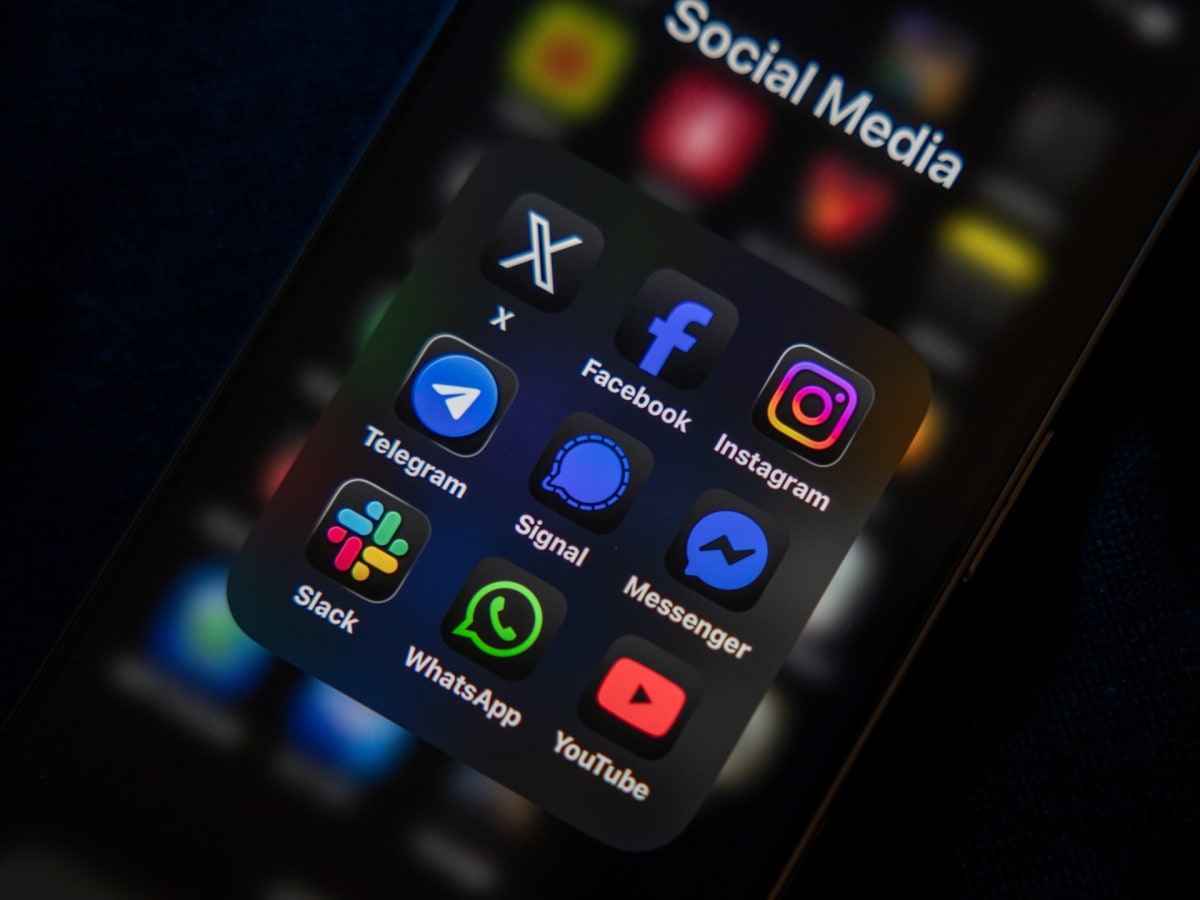 Young students using smartphones and tablets in classroom setting with parental supervision