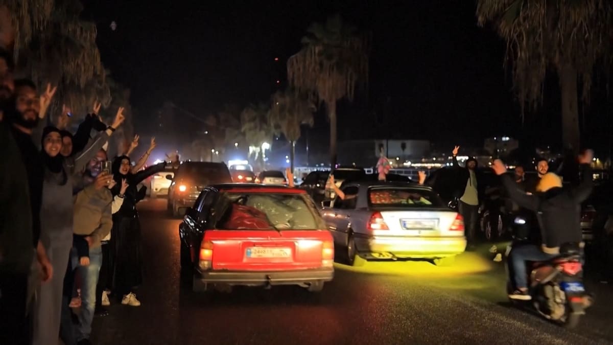 Families celebrating in cars on Lebanese roads as they return home after ceasefire begins