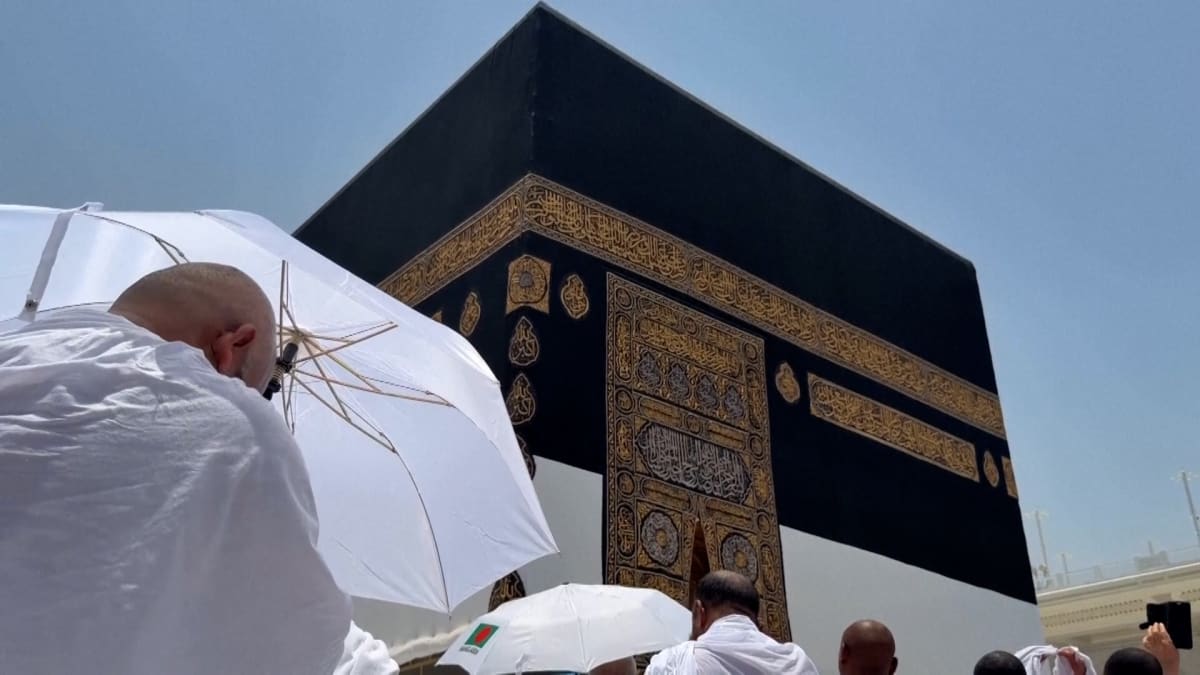 ** Large crowds of pilgrims in white garments gathering at the Grand Mosque in Mecca, Saudi Arabia