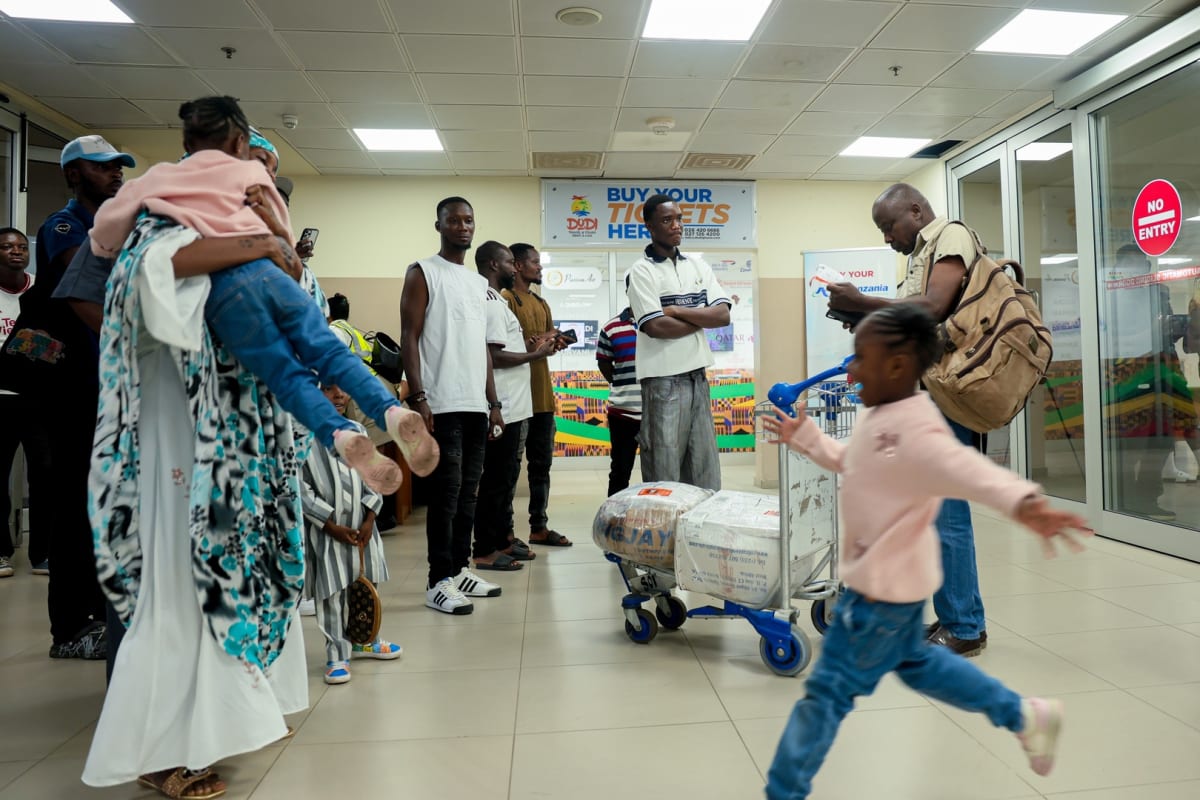 Ghanaian officials welcoming evacuated citizens arriving at Accra airport with support services