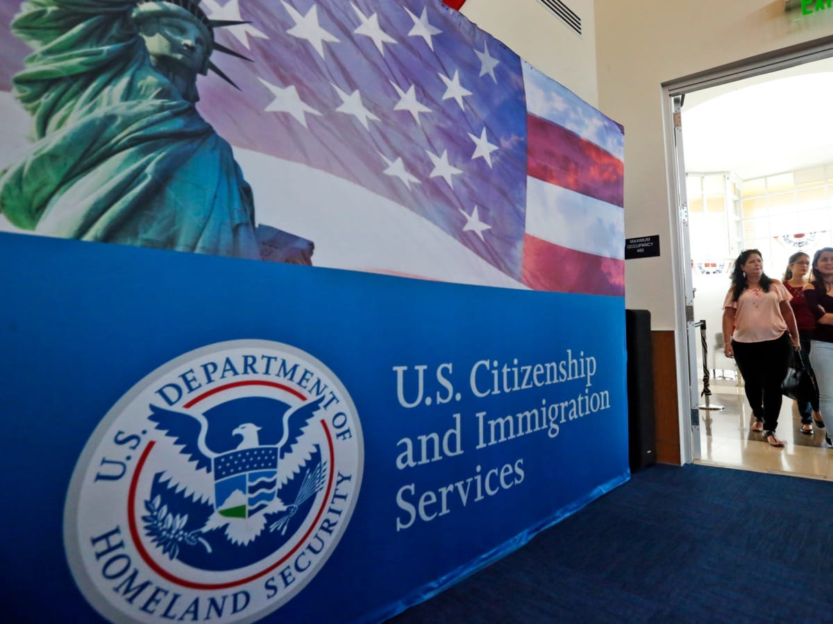 People waiting at US Citizenship and Immigration Services office for naturalization ceremony
