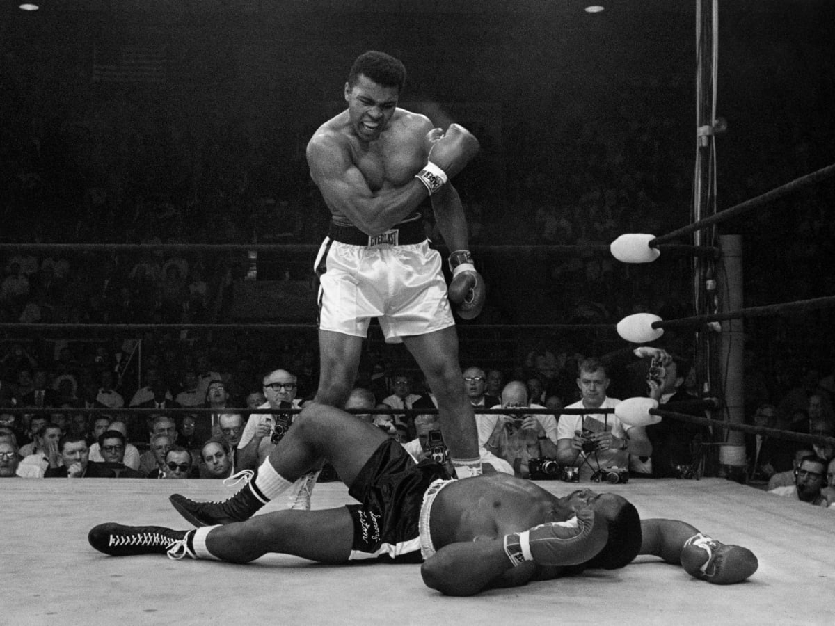 Muhammad Ali in his prime, fist raised in victory, symbolizing strength and principled courage