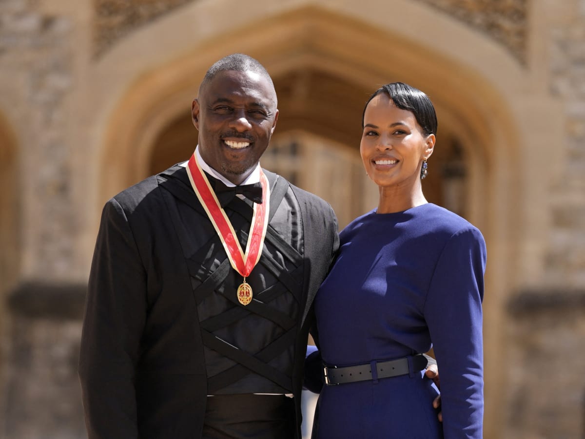 Idris Elba receiving knighthood from King Charles III at Windsor Castle ceremony