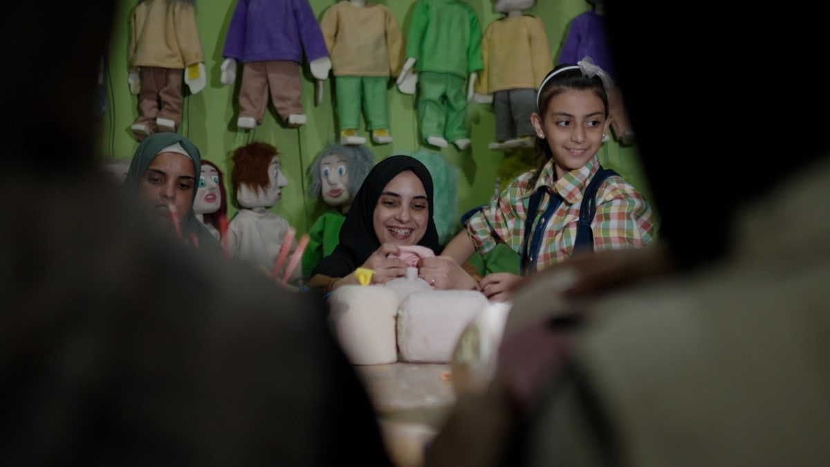 ** Children in Gaza participating in puppet theater workshop for trauma healing