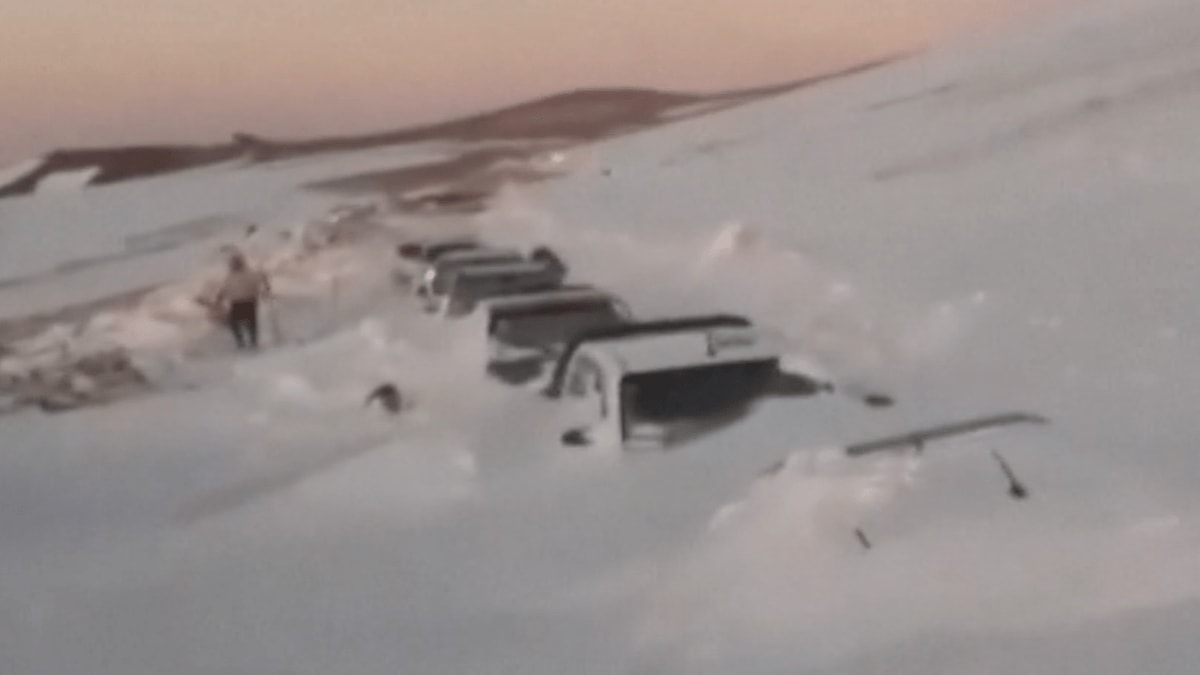 Emergency rescue vehicles clearing snow in Argentina's Andes mountains during tourist evacuation operation