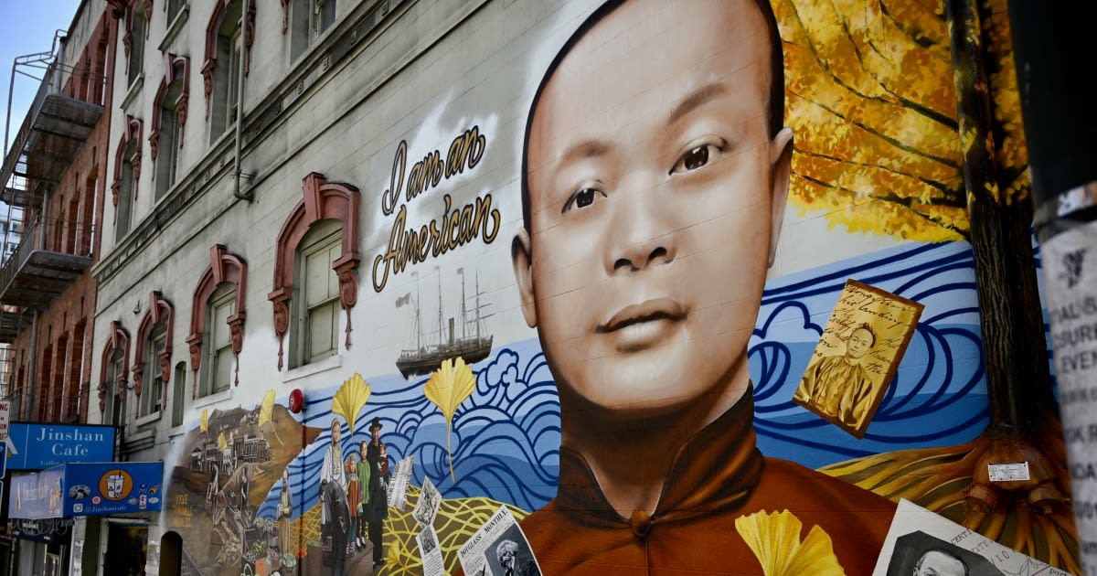 Colorful mural of Wong Kim Ark in San Francisco Chinatown displaying "I am an American"