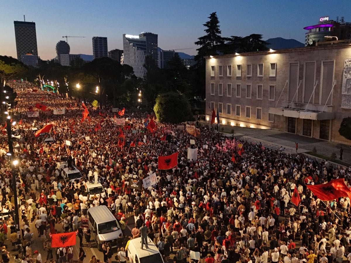 ** Peaceful protesters gather outside Albanian prime minister's office holding signs about coastal protection