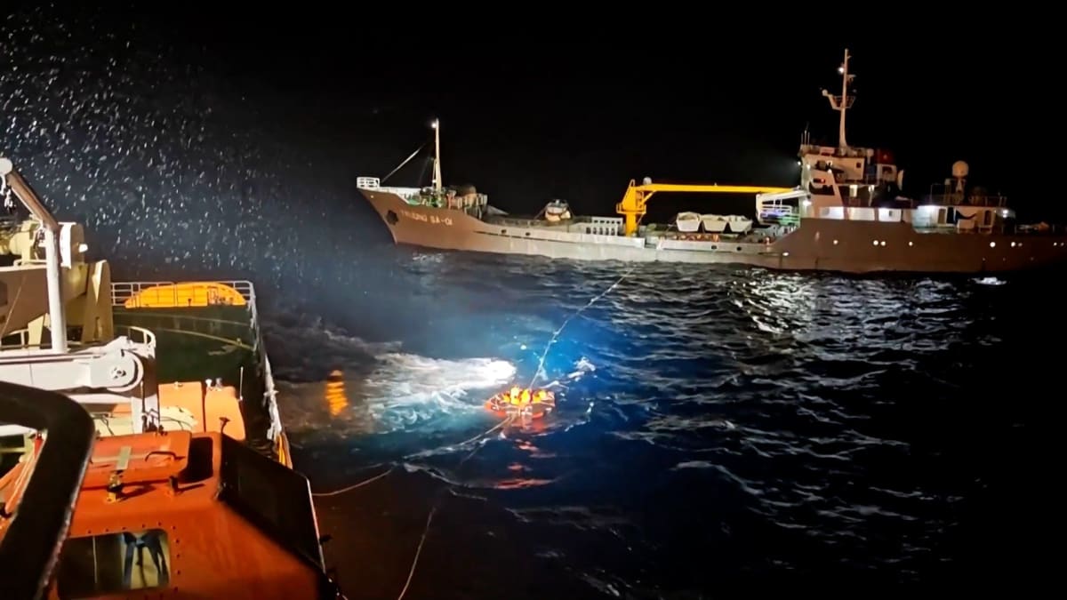 Rescue workers pulling survivors from sinking Vietnamese ship in South China Sea waters