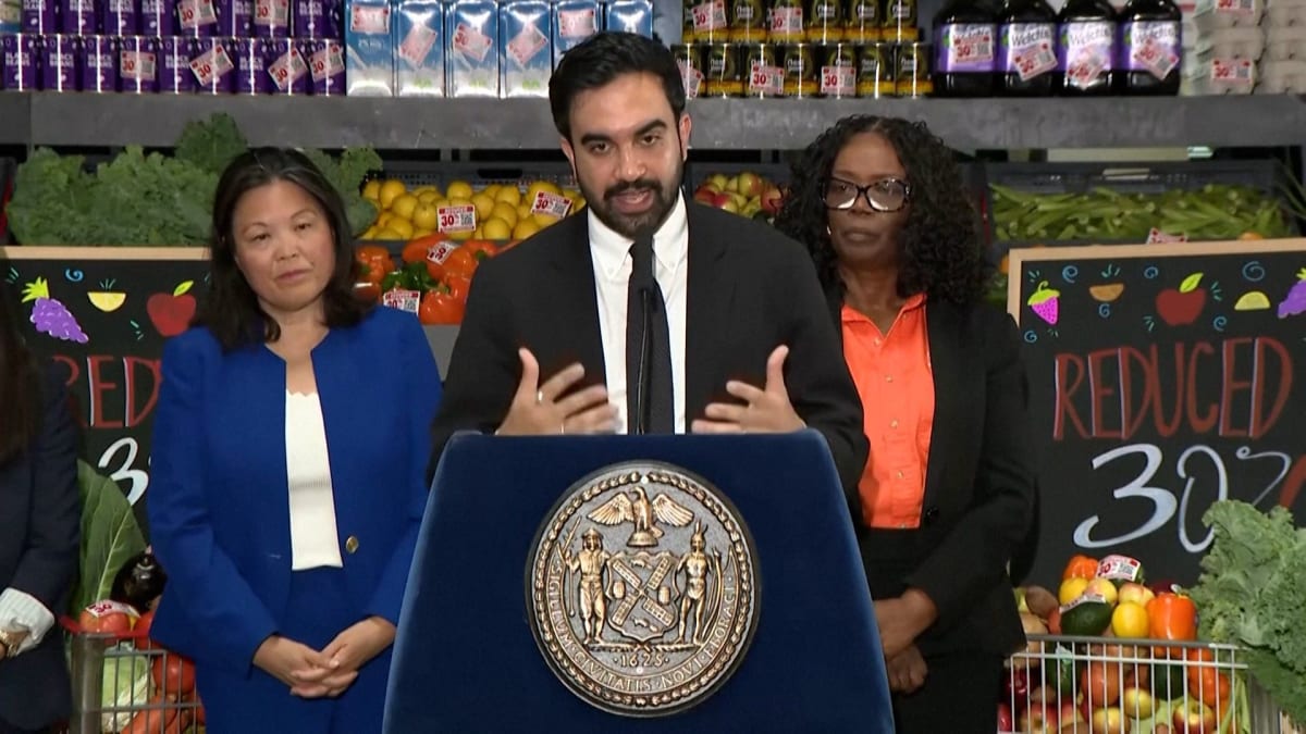 ** Shoppers browsing fresh produce and groceries at modern city-run store in New York
