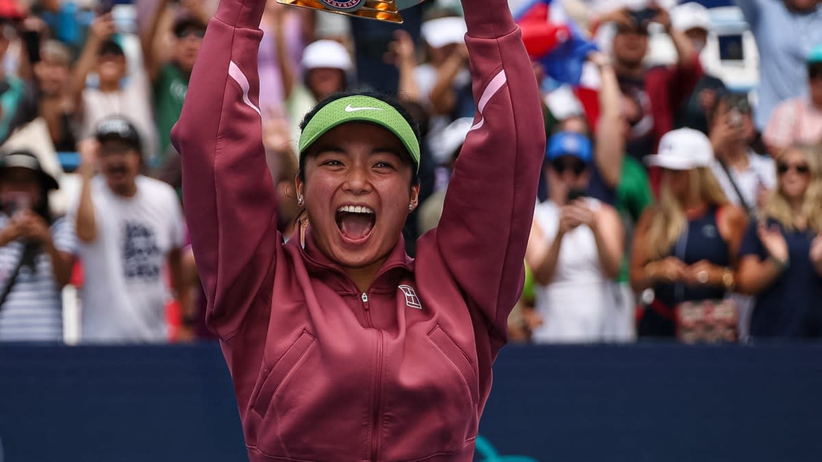 Alexandra Eala holds championship trophy above her head celebrating historic WTA victory in Washington