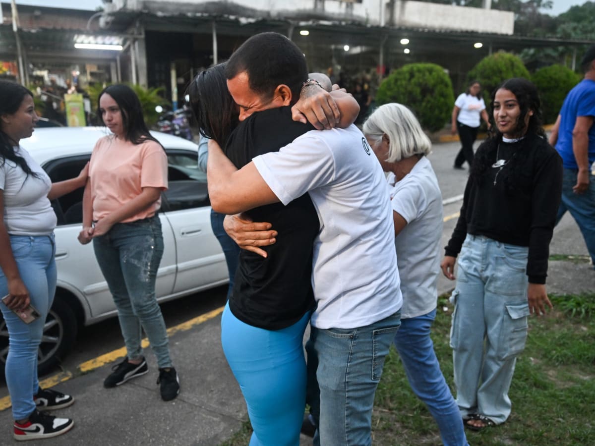 Former political prisoner Angela Vasquez embraces her brother outside El Rodeo prison in Venezuela