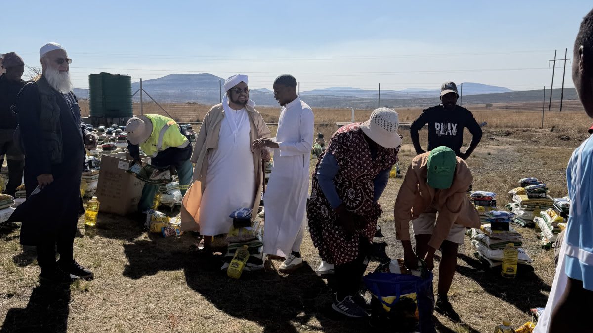 ** Khethukuthula Dlame standing at his grandfather's gravesite in rural Nquthu, South Africa