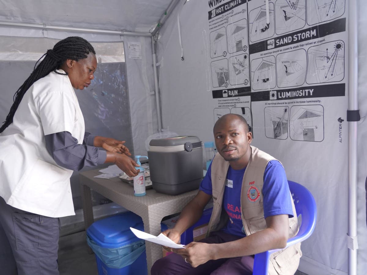 Healthcare worker in protective gear receives Ebola vaccine at treatment center in Bunia, DR Congo