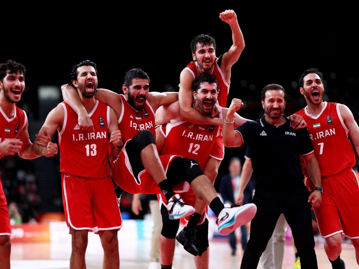Iranian basketball players celebrating emotionally on court after winning bronze medal at Asian Games