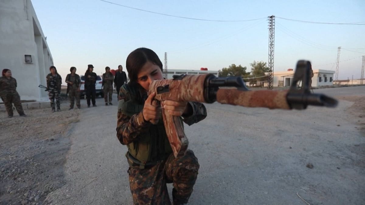 ** Kurdish YPJ women fighters in military uniform standing together in formation in Syria