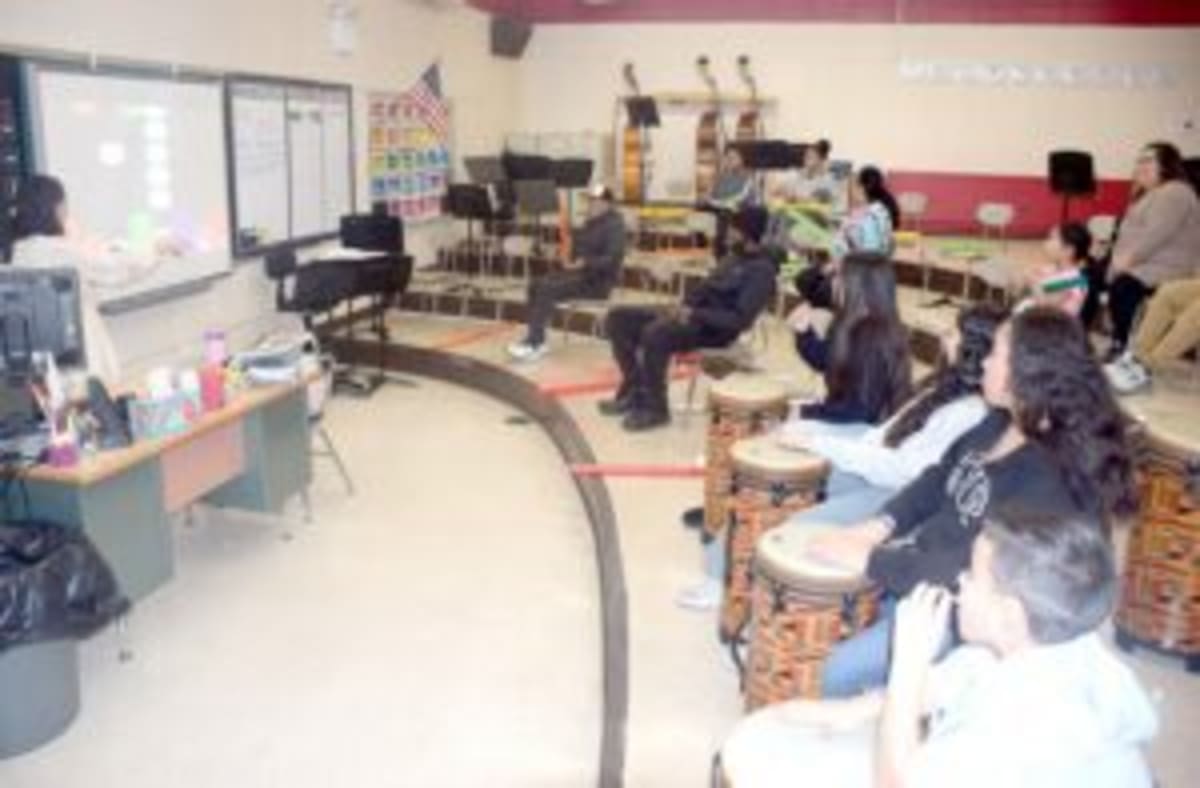 Students and parents participating in interactive musical performance at Edmund W. Miles Middle School STREAM Night