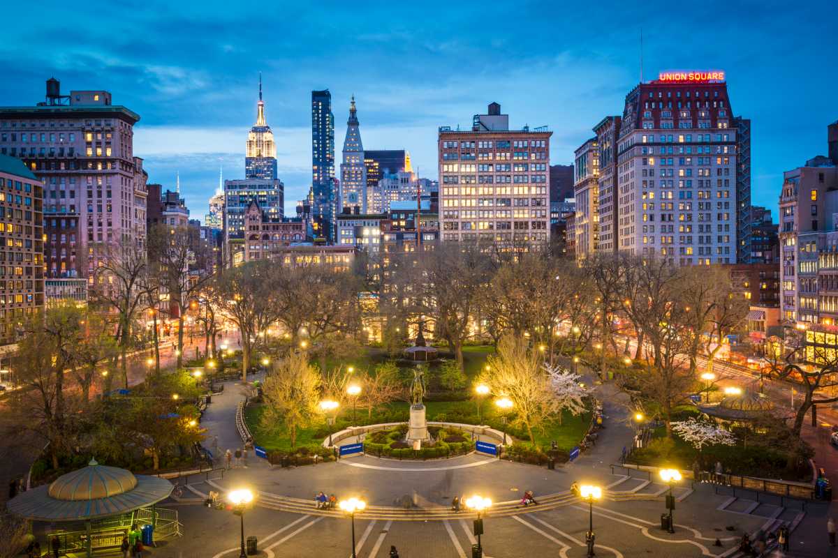 Crowded pedestrian plaza at Union Square in New York City with shoppers and storefronts
