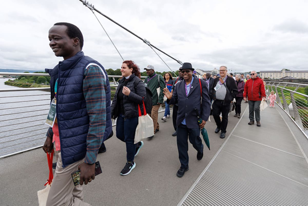 Anglican leaders including Archbishop of Canterbury crossing Peace Bridge over River Foyle in Derry