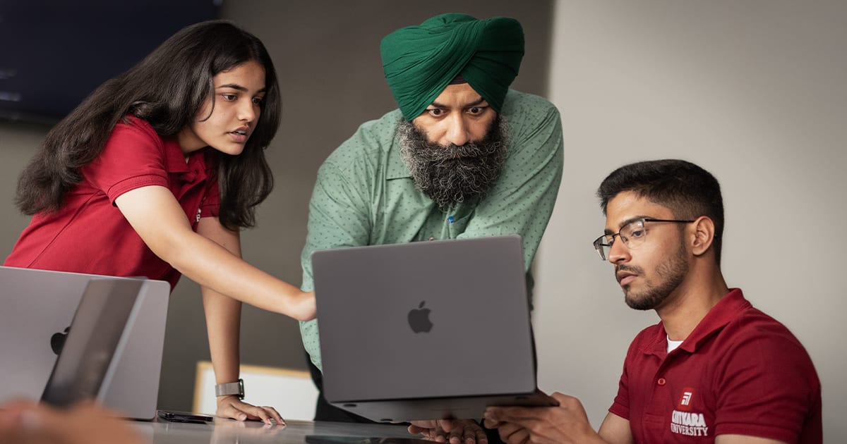 ** Indian university students collaborating on iOS app development projects in modern classroom