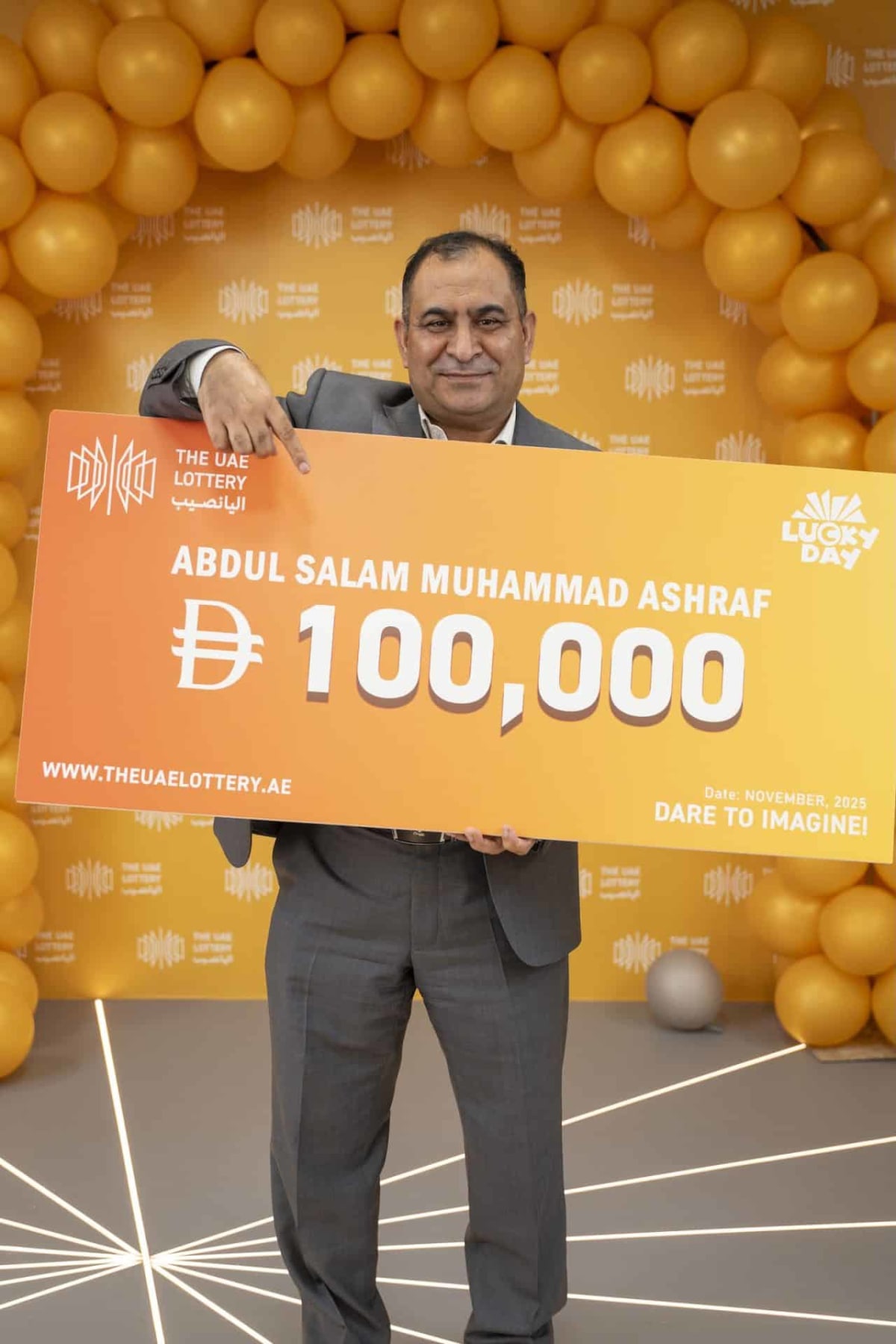 ** Smiling Pakistani limousine driver Abdul Salam standing beside vehicle in UAE