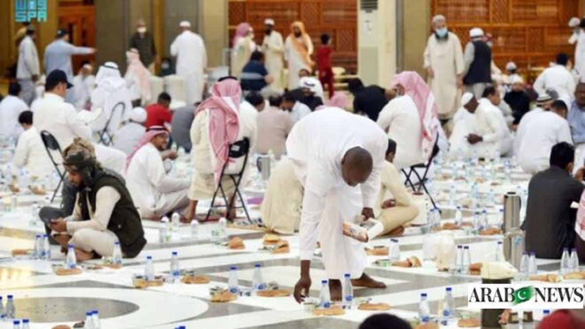 Person using smartphone to make charitable donation during Ramadan in Saudi Arabia