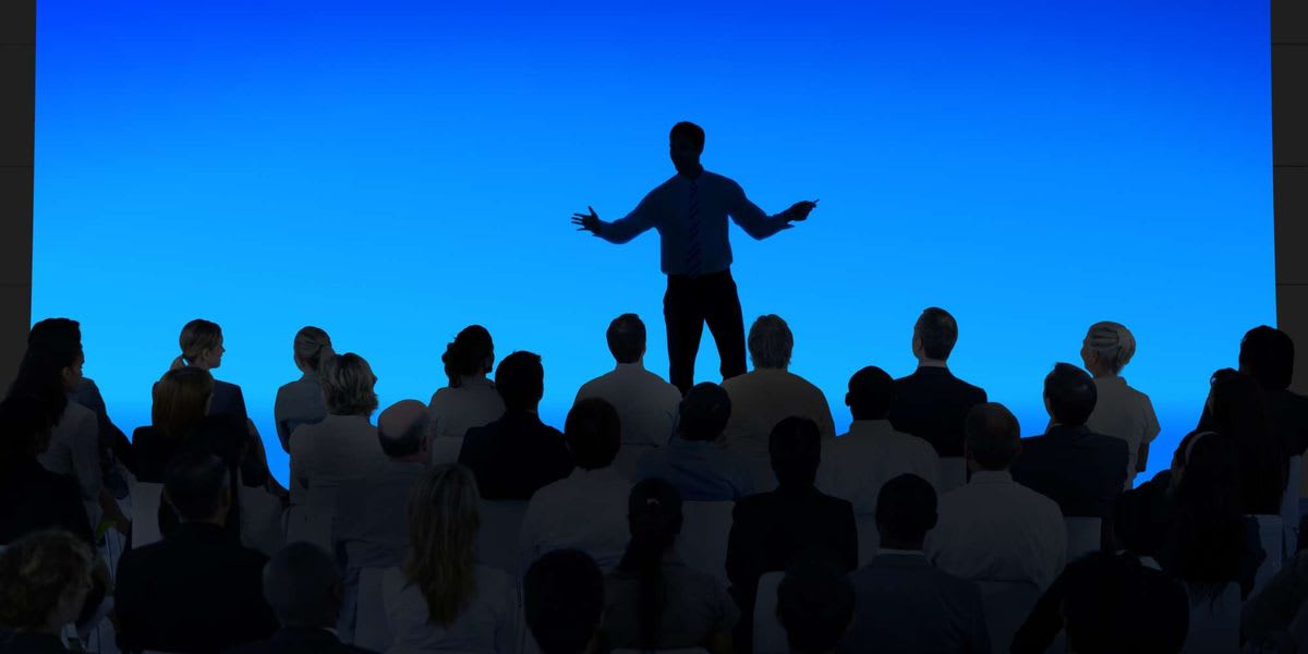 ** Crowded indoor business conference or event venue showing attendees and activity in India