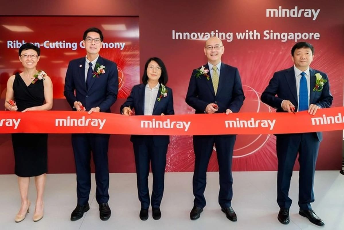 Modern medical technology facility in Singapore with researchers collaborating on advanced healthcare equipment