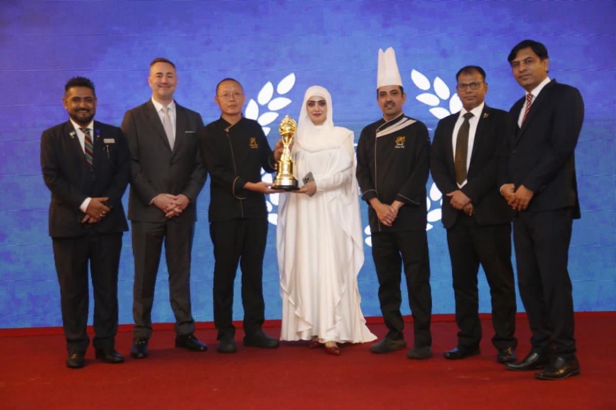Pakistani chefs celebrating at culinary victory event in Karachi with trophy display