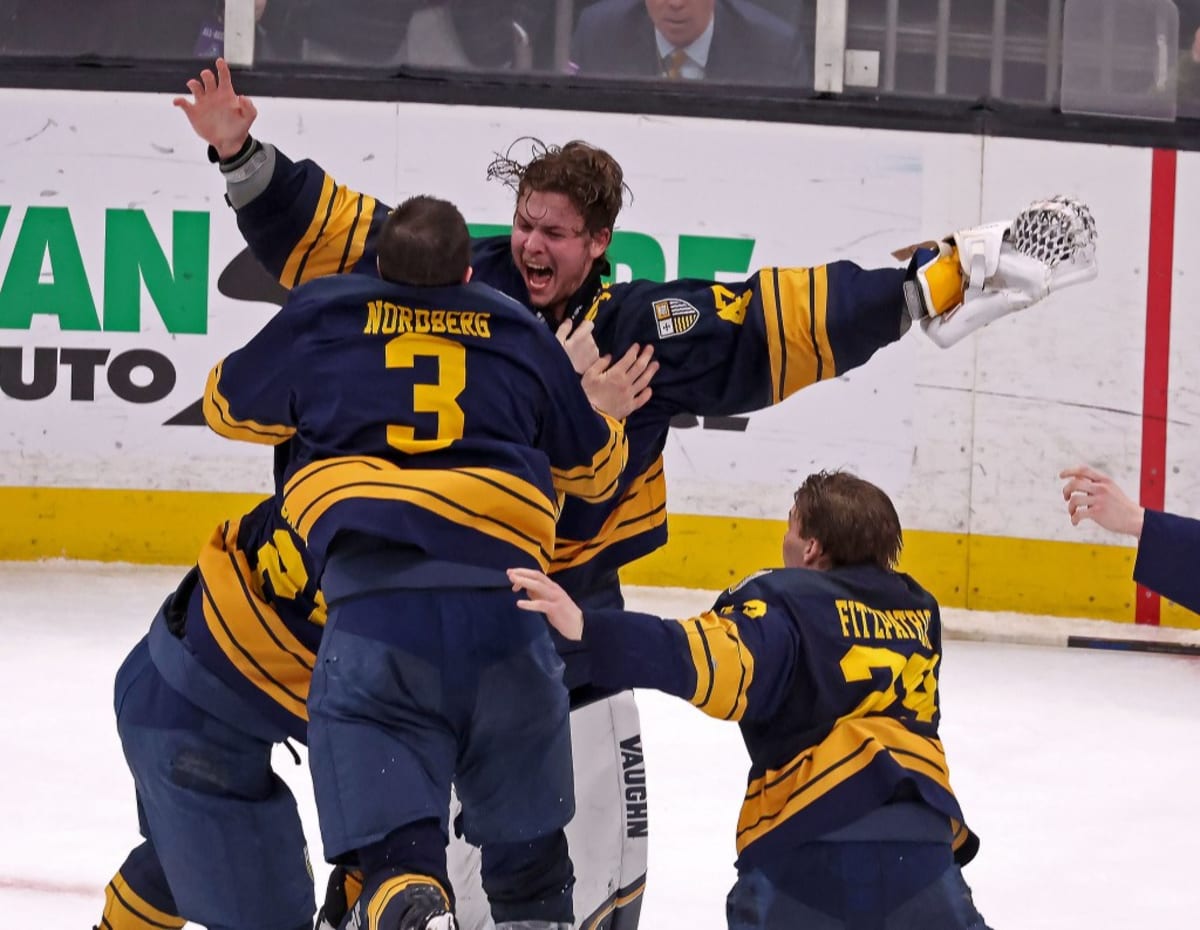 Merrimack goalie Max Lundgren celebrates with teammates after winning Hockey East Championship game