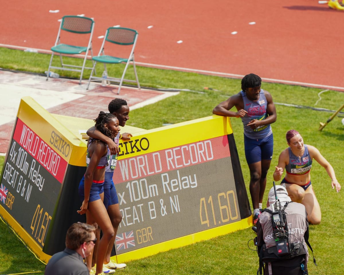 ** Young British relay runners celebrating after breaking world under-20 record at championship