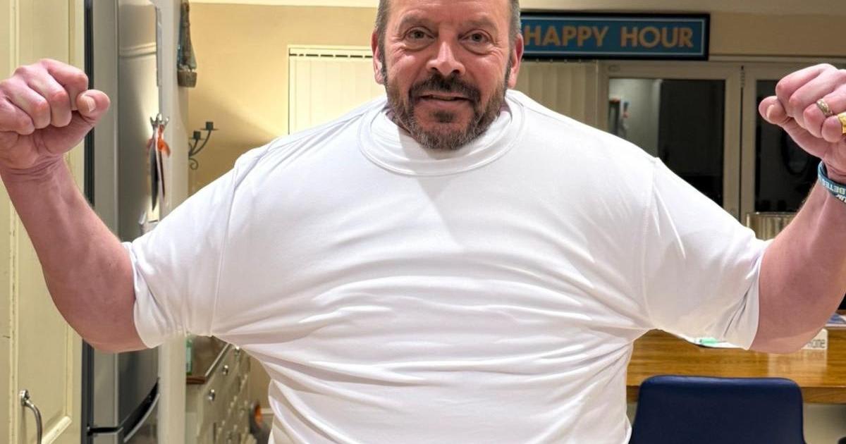 Giles Cuthbert preparing for London Marathon wearing multiple layers of T-shirts for charity