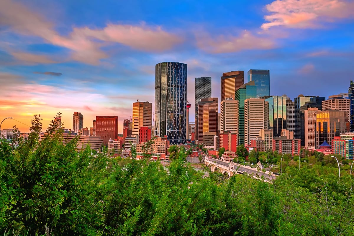Modern downtown Calgary office buildings with blue sky, representing new job growth and economic opportunity