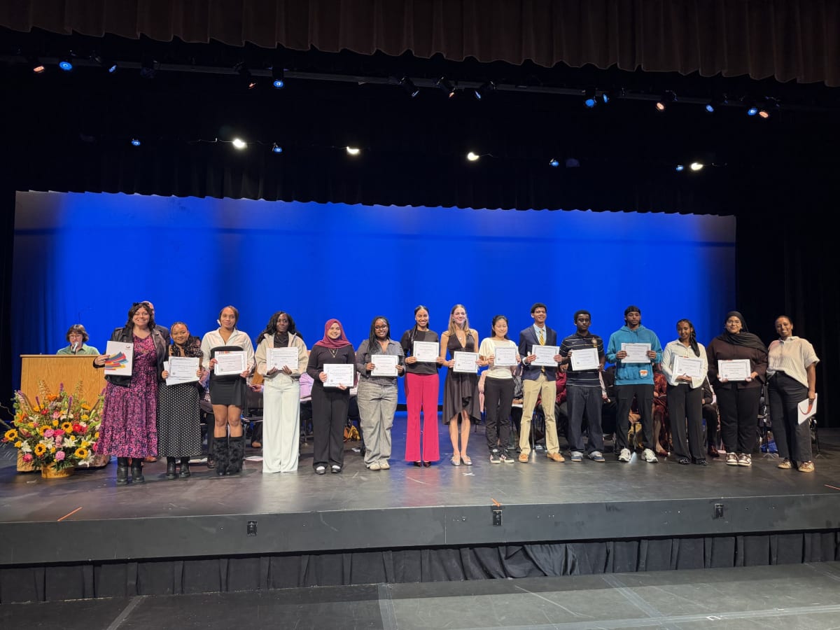 Cambridge high school student receiving scholarship award from community sponsor at ceremony