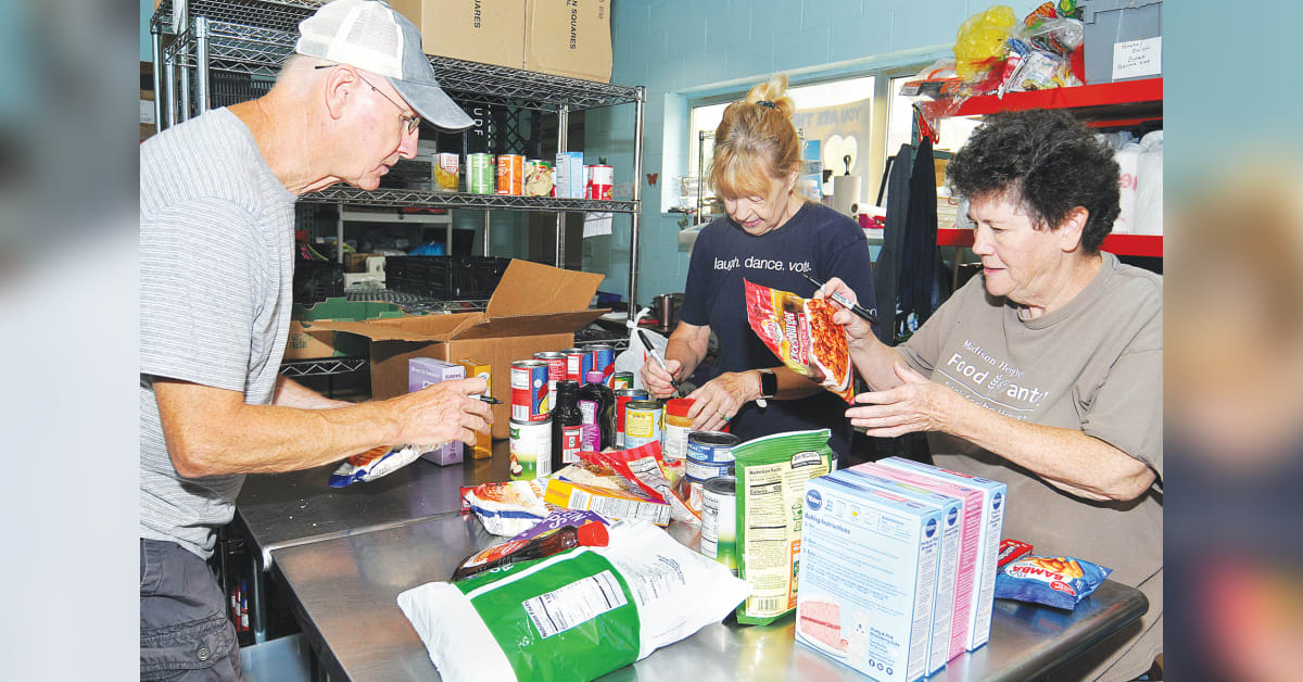 Volunteers at Madison Heights Food Pantry sorting donated food items in church space
