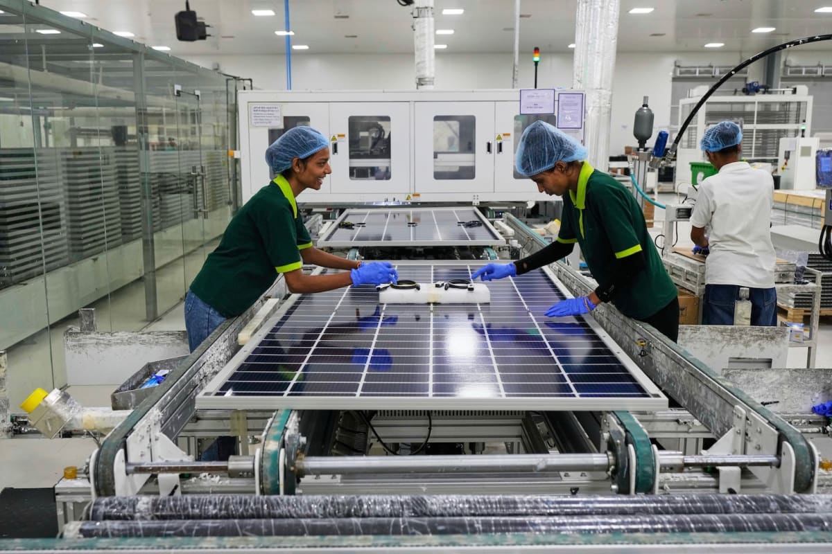 ** Workers assembling solar panels at a manufacturing facility in Jaipur, India