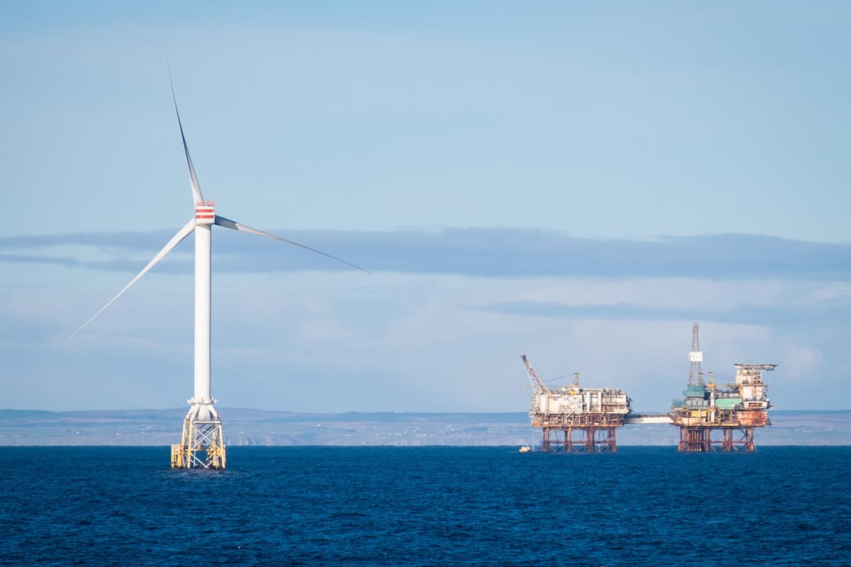 ** Wind turbine generators spinning against blue sky in Moray Firth Scotland