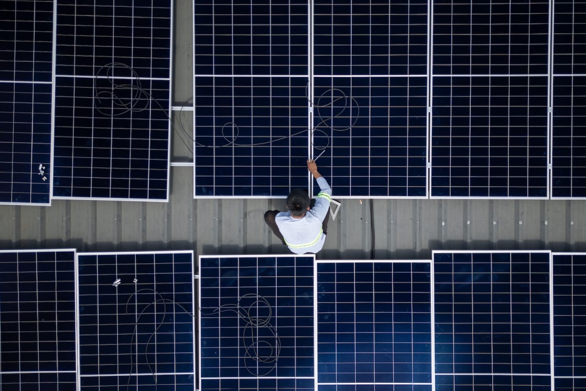 ** Solar panel installation against blue sky showing renewable energy infrastructure expansion
