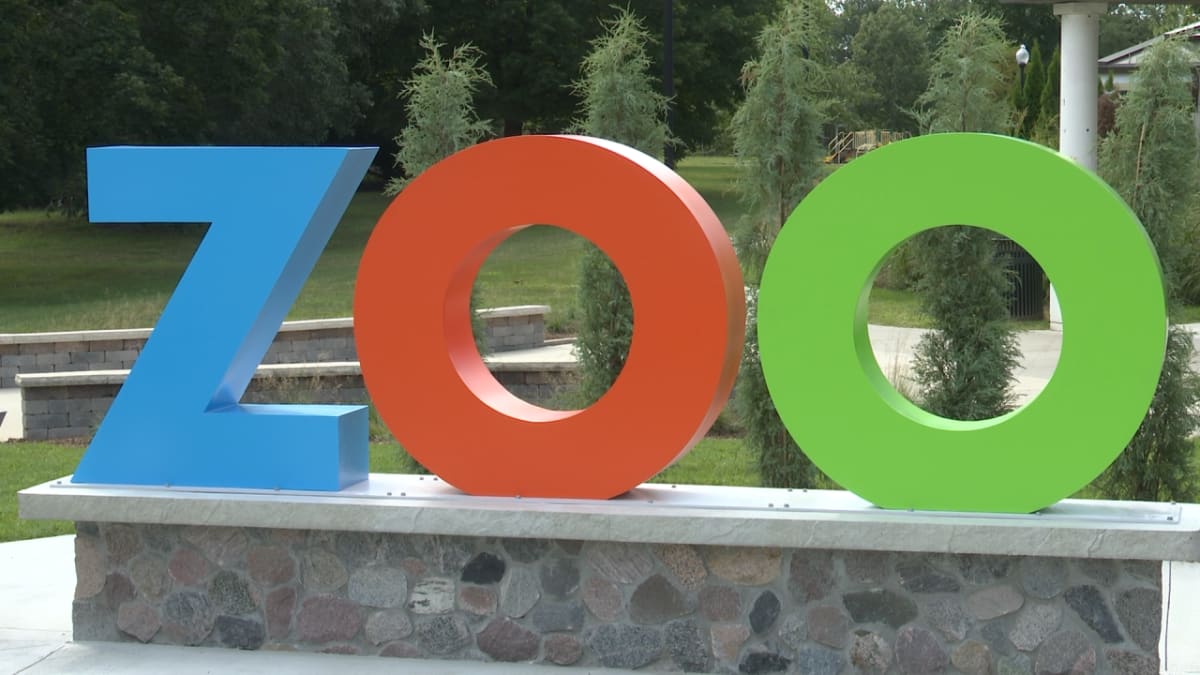 ** Families participating in educational scavenger hunt at Miller Park Zoo in Bloomington, Illinois