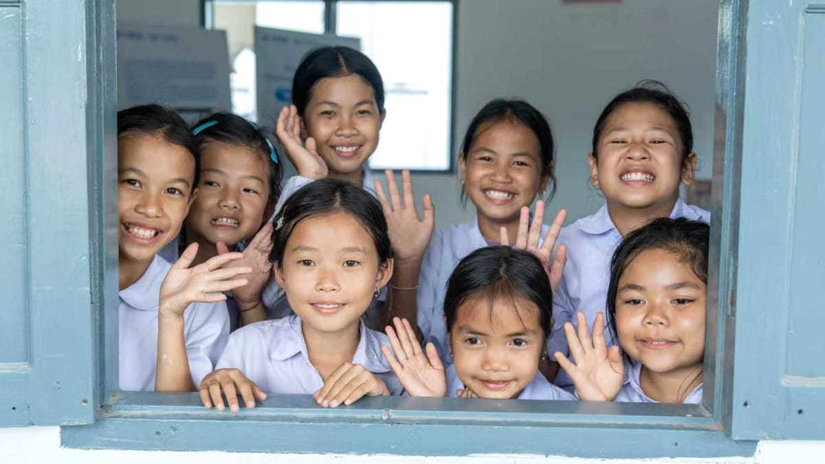 Primary school students sitting in new bright classroom in Thinsom village, Laos