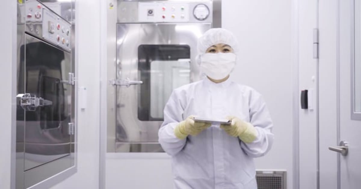 Scientists in laboratory examining vials during pharmaceutical research and drug development process