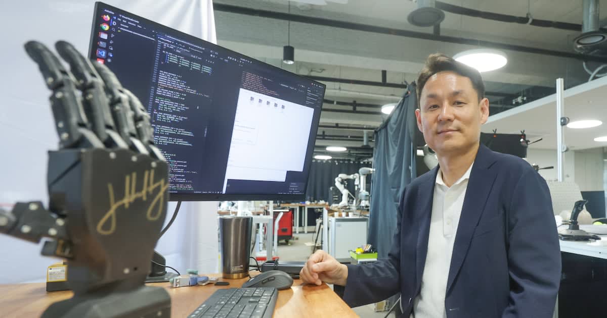 Robotic hand and water-strider robot on desk at Seoul National University Robotics Research Institute