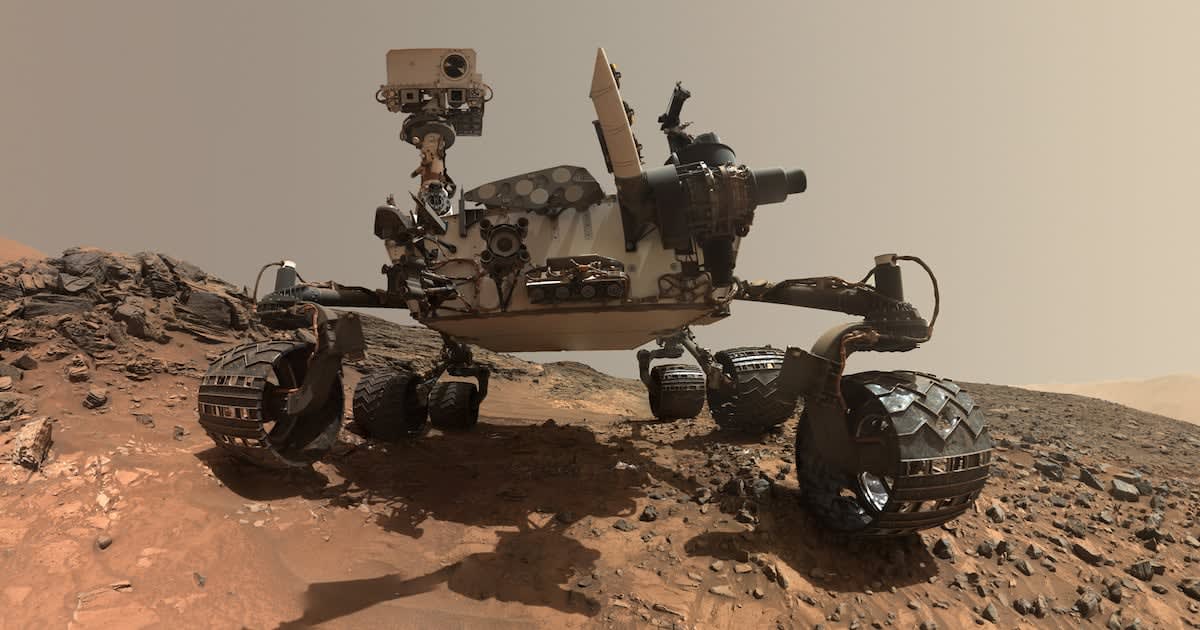 NASA's Curiosity rover on the red Martian surface exploring ancient rock formations