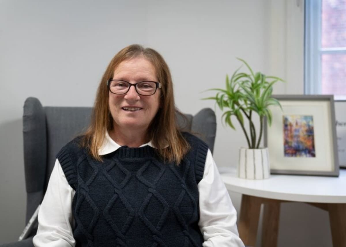 Grandmother Angela smiling confidently after completing stroke recovery program in Scotland