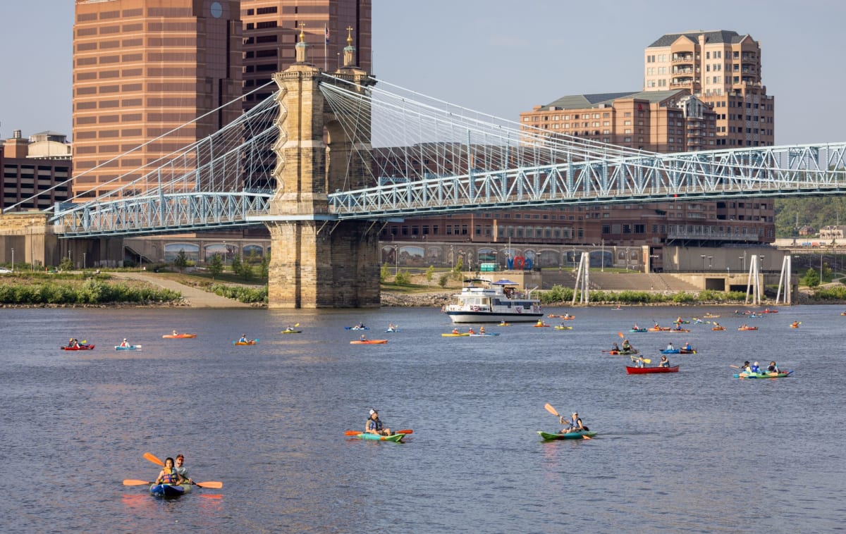 Hundreds of colorful kayaks and paddleboards gathered together on the Ohio River during annual festival