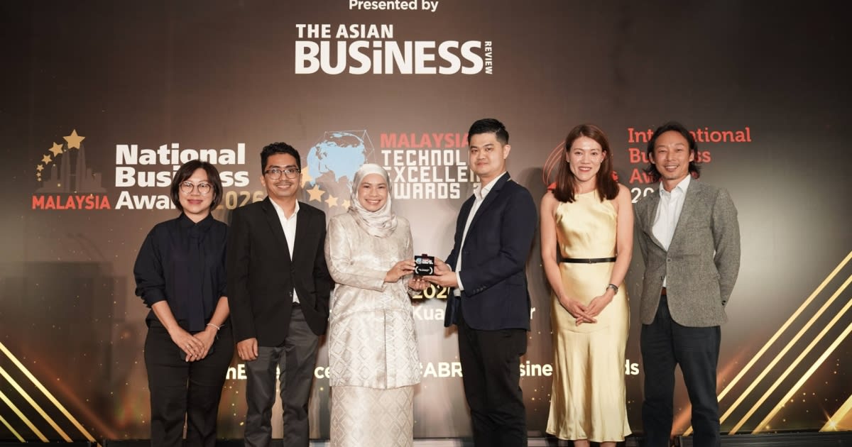Modern office worker using multilingual AI chatbot on computer screen in Malaysian pharmaceutical company
