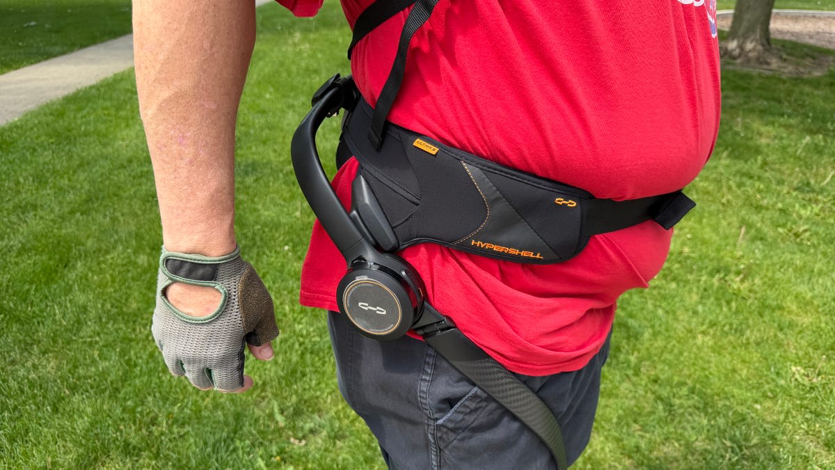 Man wearing lightweight exoskeleton device around waist and legs while hiking rocky Grand Canyon trail