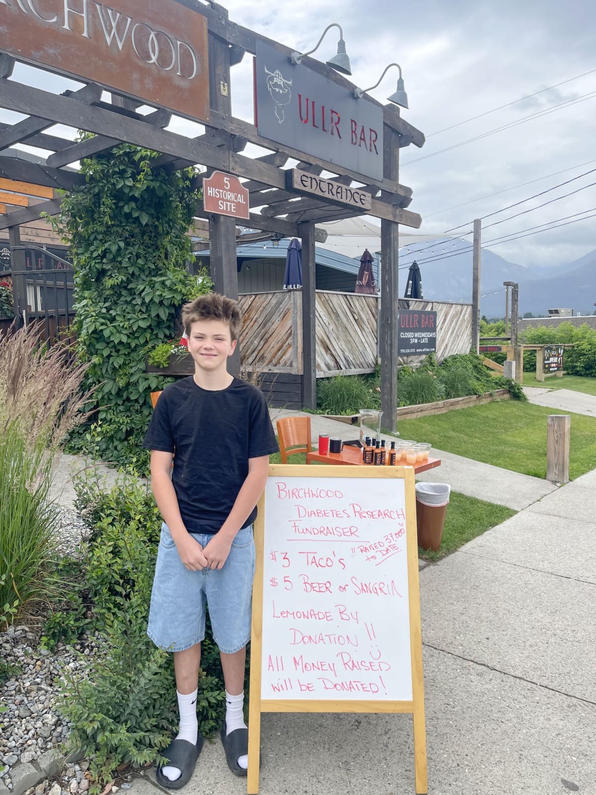 Teen Max LeBlanc smiling at his Canada Day fundraising stand for Type 1 diabetes research