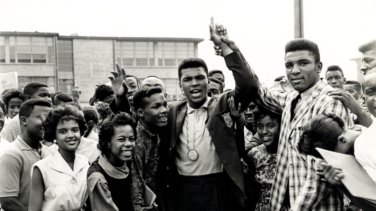 Young Cassius Clay standing on Olympic podium receiving gold medal in Rome 1960