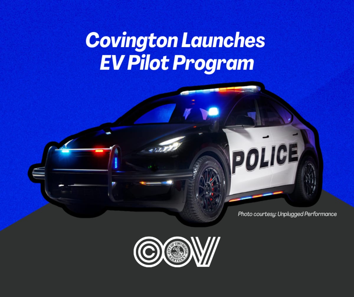 Electric police SUV charging at public station in Covington, Kentucky municipal parking garage